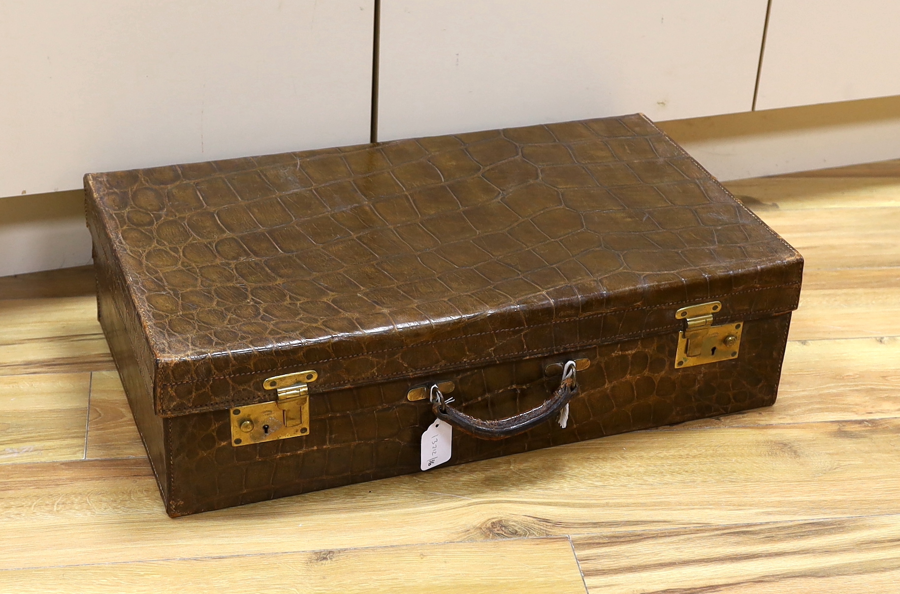 A Vintage 1930’s crocodile skin travelling case, 65cm wide